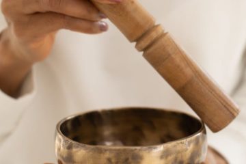 close up shot of a person using a singing bowl
