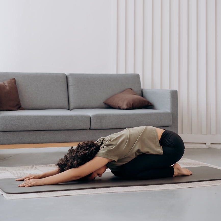 woman in brown shirt in a bending position