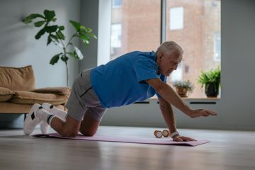 an elderly man exercising on a yoga mat